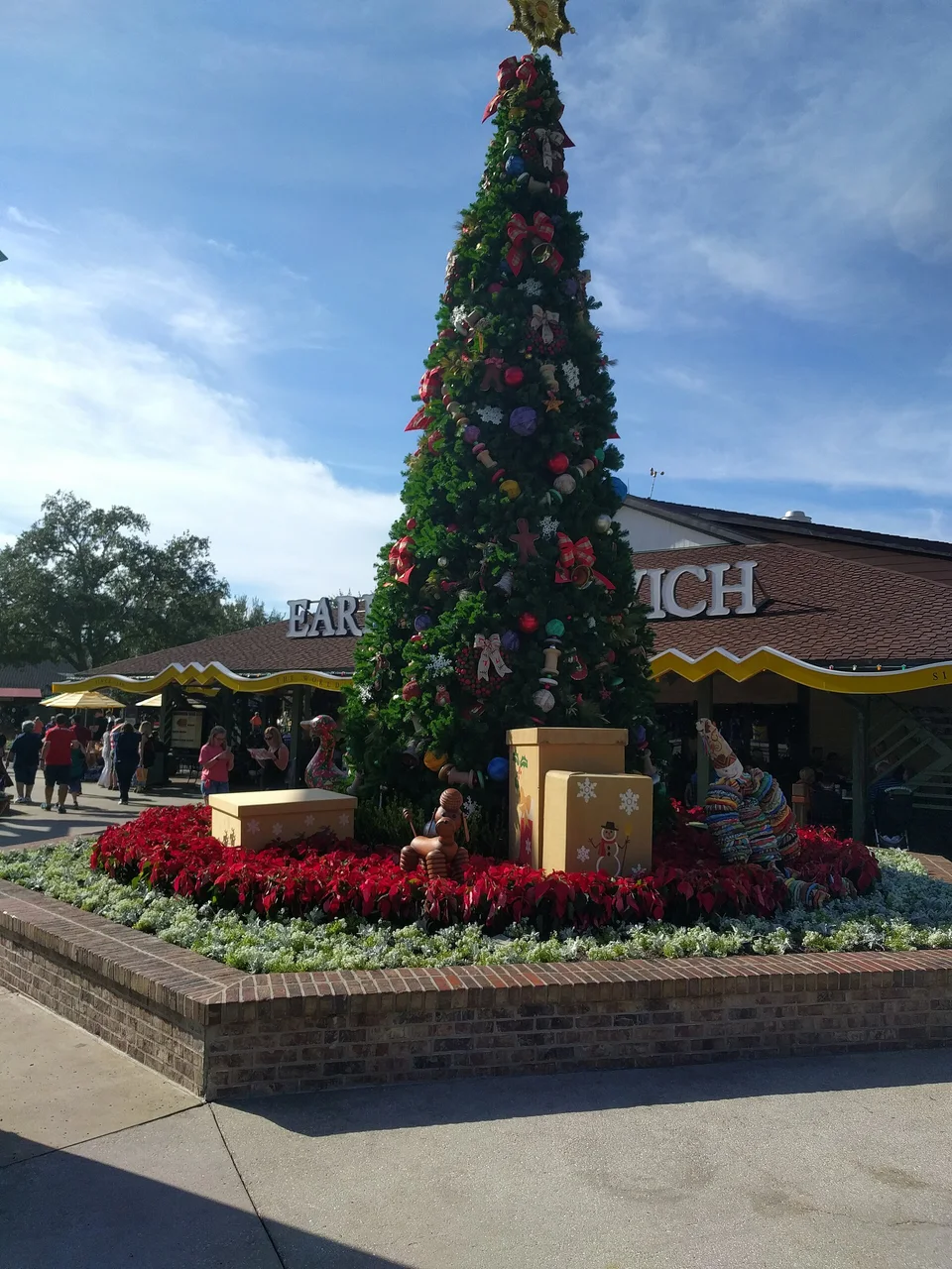 Christmas tree in the Marketplace area of Disney Springs, Florida, in daylight. Archival photograph from 2016. Disney Springs is a separate venue from Magic Kingdom.