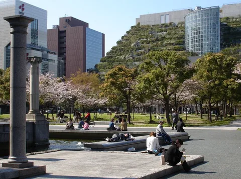 Pelouse du parc central de Tenjin et terrasses végétales d’ACROS Fukuoka de jour en avril 2005
