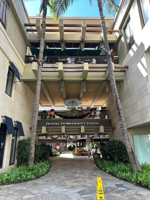 Palmengesäumter Durchgang mit Girlanden im Royal Hawaiian Center. Archivbild des Ortes; weder der Baum im Royal Grove noch die Dekoration 2026 sind abgebildet.